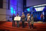 sunrise over river|||||pastor ed receives check for building