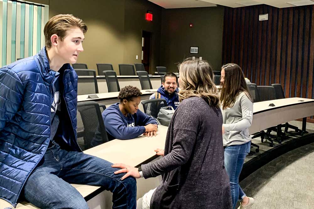 students talking in the fishbowl classroom at Oklahoma Wesleyan University