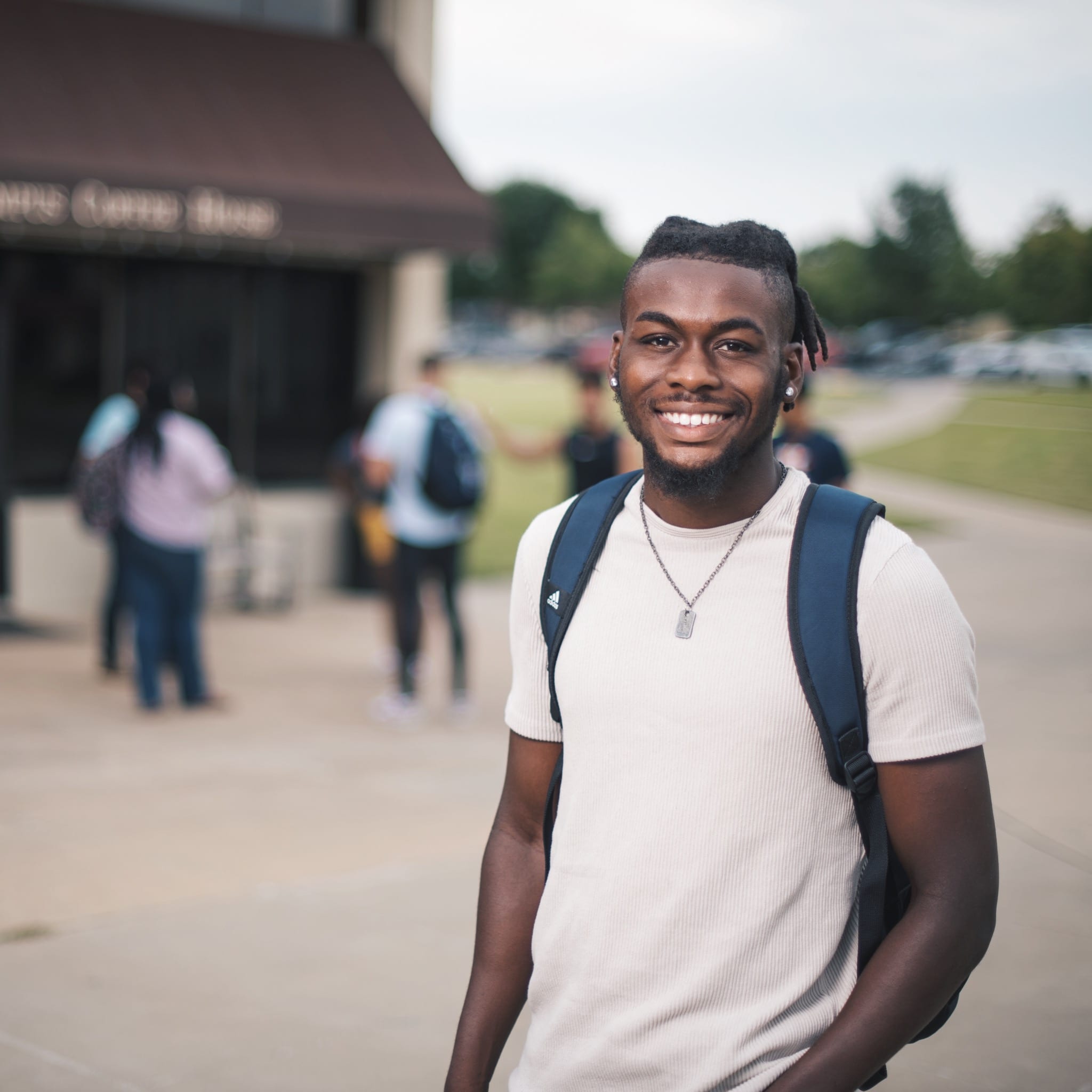 Student standing in front of Doc Lacys at Oklahoma Wesleyan University