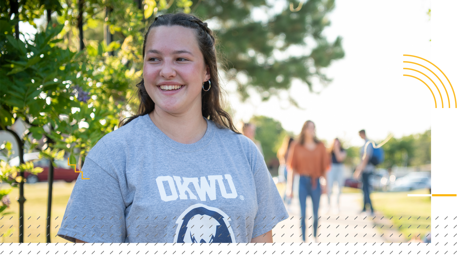 student smiling at alumni gate