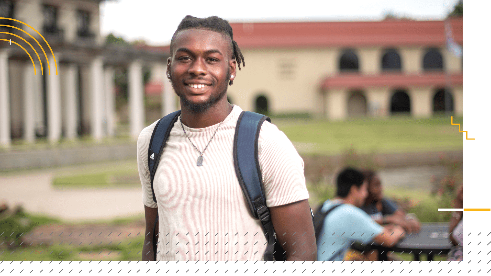 student-library-friends student smiling in front of sports center and library