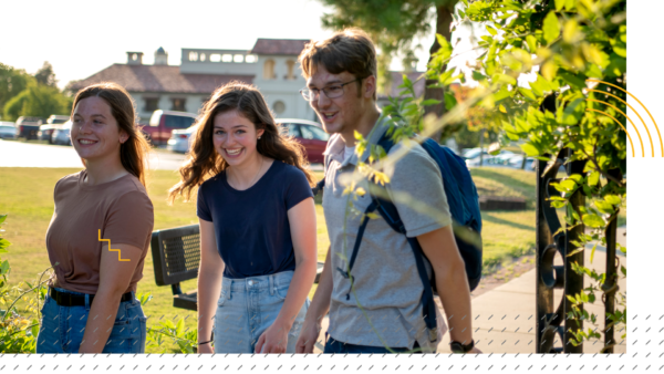 students-elements-gate students smiling as they enter campus gateway