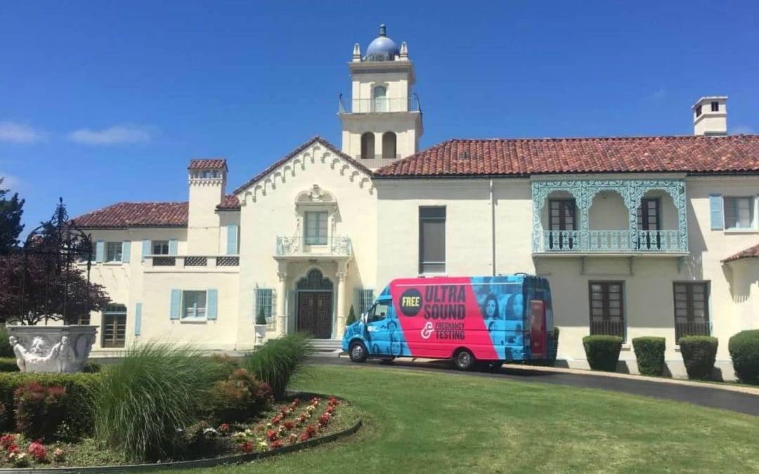 Ultrasound van in front of mansion