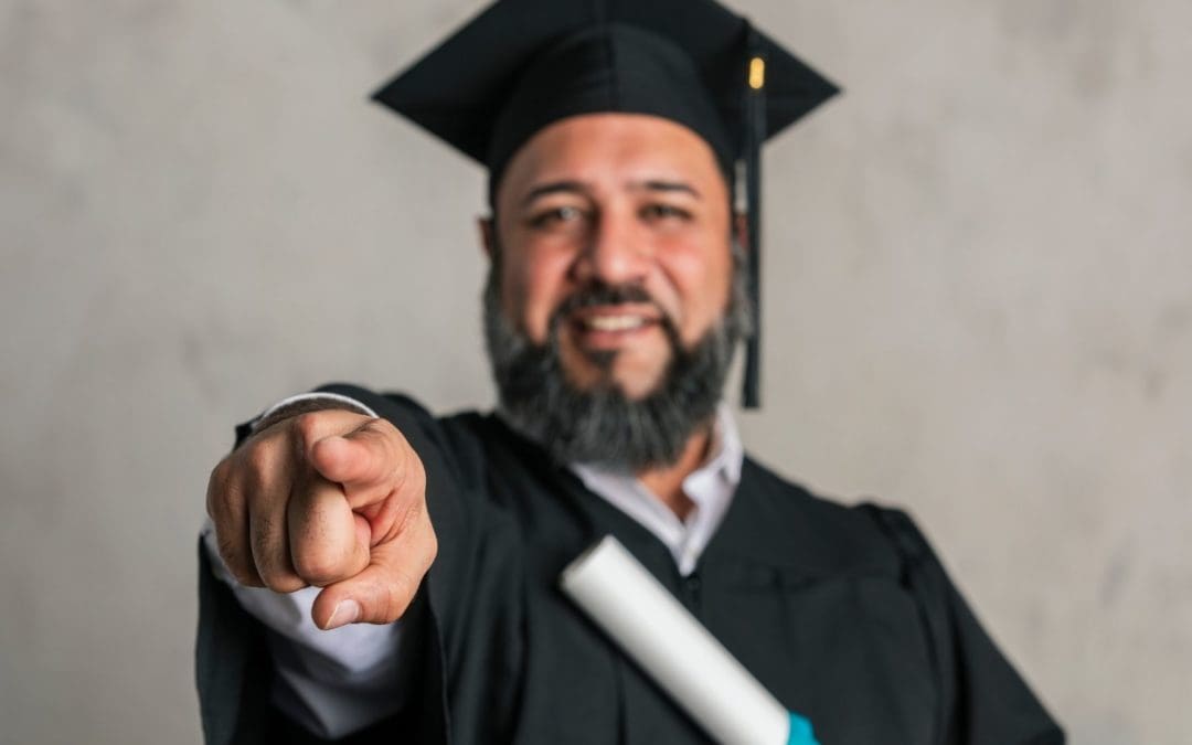 man with degree pointing