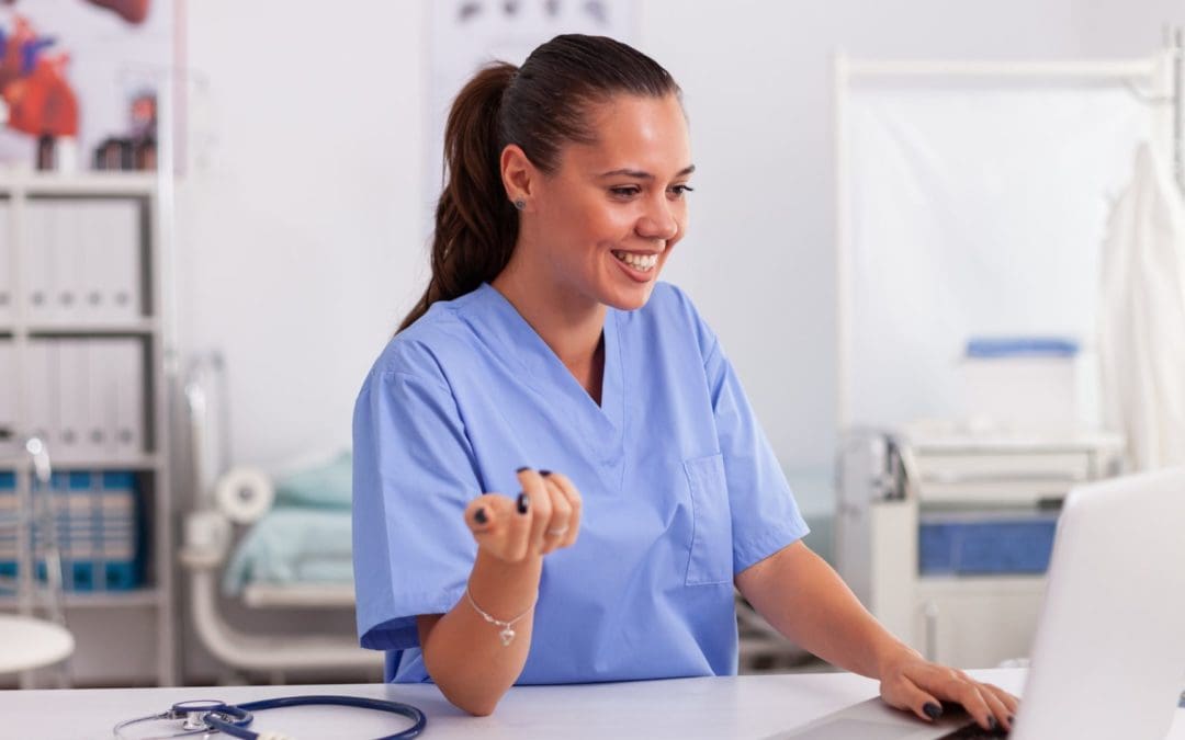 Nurse Smiling at Computer