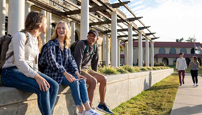 traditional-financial-aid Students sit outside OKWU's library