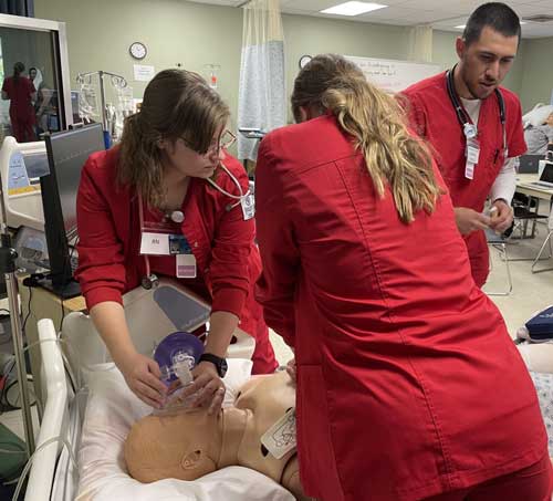 nursing-simulator School of Nursing students testing their skills out on the simulator.