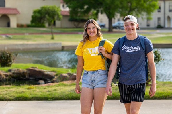 Two students walking together on campus