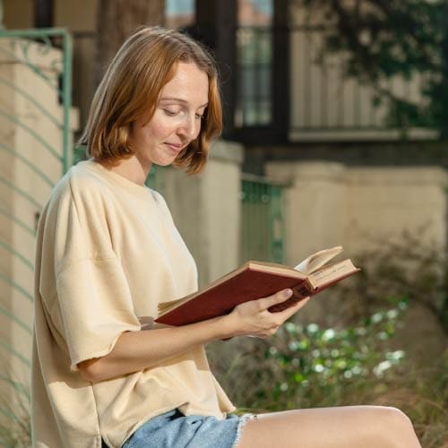 OKWU Student studying in the mansion garden