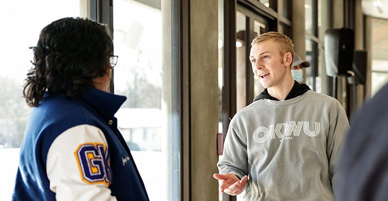 student-meeting-with-admissions-mobile student smiling at alumni gate