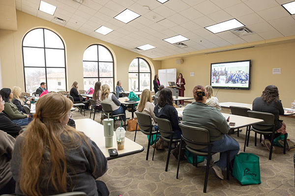 Event attendees engaging with session presentation.