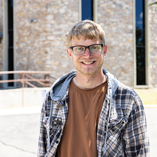 Nathan Wall standing outside a church